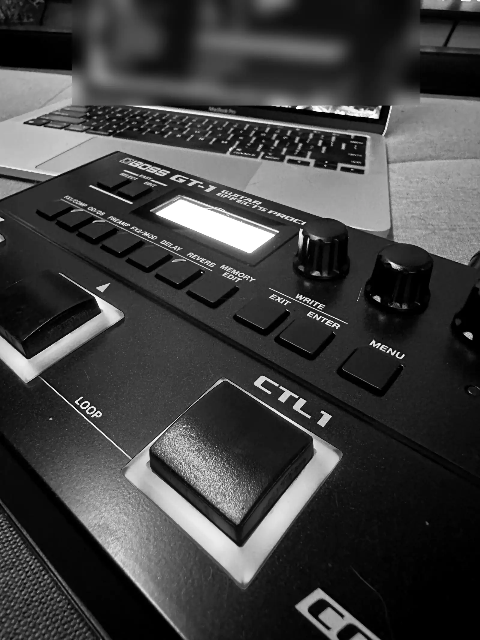 The BOSS GT-1 next to a laptop, in black and white